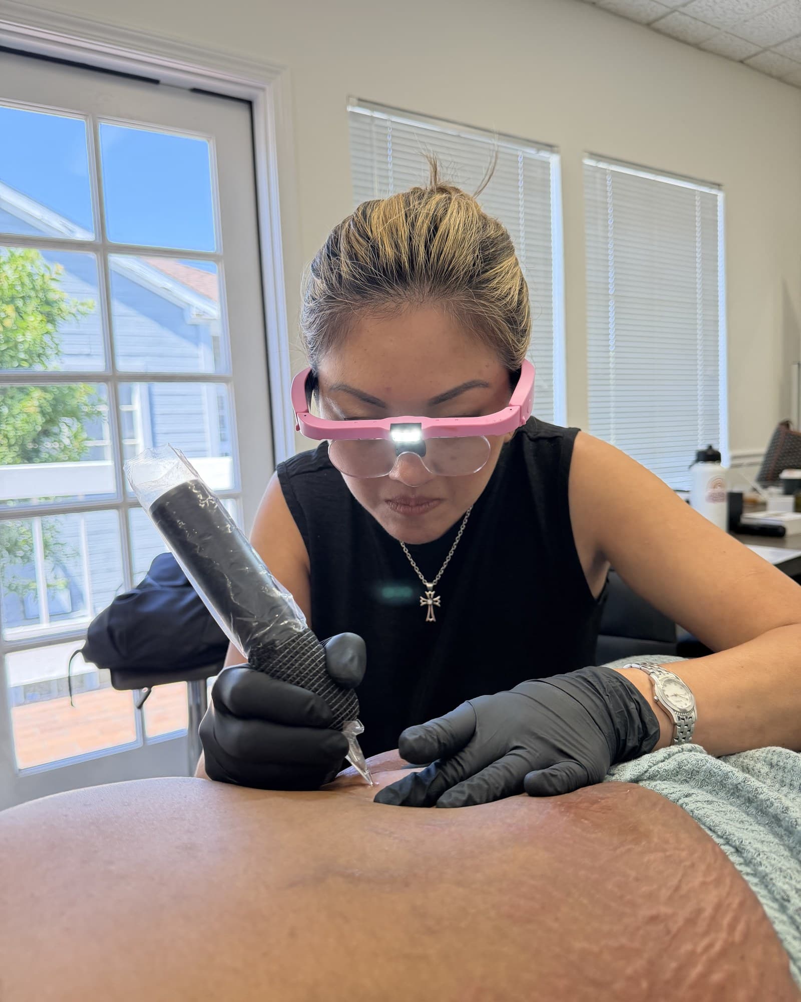 Cindy Keyes concentrating while performing a restorative tattoo procedure.